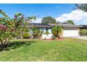 Charming ranch home with lush landscaping and solar panels at 8460 Parkwood Blvd, Seminole, FL 33777