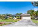 Single story home with a spacious yard and driveway at 8460 Parkwood Blvd, Seminole, FL 33777