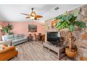 Spacious living area with light wood floors, stone accent wall, and comfy seating at 8460 Parkwood Blvd, Seminole, FL 33777