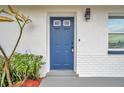 Blue front door and white brick exterior at 9850 55Th N Way, Pinellas Park, FL 33782