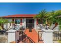 Inviting front entrance with a brick walkway, decorative railings, and landscaping with potted plants at 1723 Wolf Laurel Dr, Sun City Center, FL 33573