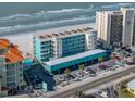Aerial view of beachfront property showing building, parking, and beach at 19440 Gulf Blvd # 301, Indian Rocks Beach, FL 33785