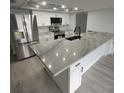 Modern kitchen featuring white cabinets, granite countertops, and stainless steel appliances at 2048 Tumbleweed Dr, Holiday, FL 34690