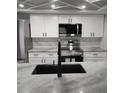 Modern kitchen with white cabinets, granite countertops and black sink at 2048 Tumbleweed Dr, Holiday, FL 34690