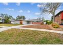 Ranch-style home showcasing a well-maintained lawn and driveway at 2124 16Th Sw Ave, Largo, FL 33770