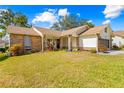 One-story brick home with a large front yard at 2249 Grandfather Mtn, Spring Hill, FL 34606