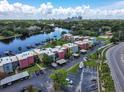 Aerial view of colorful townhomes on the water with docks and cityscape views beyond the treeline at 2424 W Tampa Bay Blvd # B201, Tampa, FL 33607