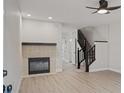Living room with fireplace and stairs at 291 Winchester Way, Palm Harbor, FL 34684