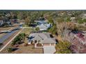 Aerial view of a single-Gathering home with a two-car garage and a landscaped yard at 377 Jenico Ct, Spring Hill, FL 34609