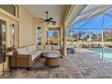 Relaxing poolside patio with wicker furniture and a view of the pool at 377 Jenico Ct, Spring Hill, FL 34609