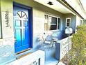 Inviting front porch with blue door and seating at 3843 19Th N Ave, St Petersburg, FL 33713