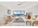 Bright living room with sliding glass doors to balcony showcasing water views and comfortable seating arrangement at 400 Island Way # 1404, Clearwater Beach, FL 33767