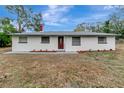 Newly renovated single story home with a modern exterior and landscaped yard at 40242 Sunburst Dr, Dade City, FL 33525
