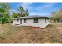 Side view of a charming ranch-style home showcasing its newly renovated exterior at 40242 Sunburst Dr, Dade City, FL 33525