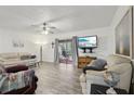 Bright living room with light gray flooring, ceiling fan, slider to patio and comfortable seating at 5328 Ridgewell Ct, Tampa, FL 33624