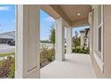 Covered front porch with white columns, offering a welcoming entrance to the home at 6314 Roadstead Ct, Apollo Beach, FL 33572