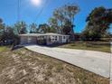 Newly renovated home with a long driveway and mature trees at 1116 E Boyer St, Tarpon Springs, FL 34689