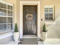Attractive dark brown front door decorated with a natural wreath at 11616 Crest Creek Dr, Riverview, FL 33569