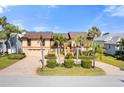 Two-story house with a double garage and palm trees at 127 6Th E St, Tierra Verde, FL 33715