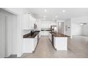Modern kitchen with white cabinets, granite countertops, and stainless steel appliances at 13580 Willow Bluestar Loop, Riverview, FL 33579