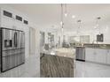 Modern kitchen with granite countertops and white cabinetry at 15214 Octavia Ln, Odessa, FL 33556