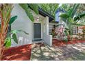 Inviting front entrance with a dark gray modern door and well-manicured landscaping at 1702 E Fern St, Tampa, FL 33610