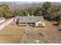Aerial view of a single story home with a large backyard and a paved driveway at 17852 Fancy Ln, Hudson, FL 34667