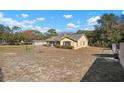 Side view of a single-story house with a large backyard at 17852 Fancy Ln, Hudson, FL 34667