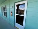 Entrance to condo unit 78, featuring a teal door and exterior at 2042 Australia W Way # 78, Clearwater, FL 33763