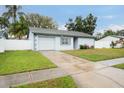 Single-story home with attached garage and a nicely kept lawn at 5127 Chatsworth Ave, Tampa, FL 33625