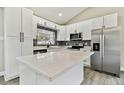 Modern kitchen with white cabinets, quartz countertops, and stainless steel appliances at 516 Highview N Cir, Brandon, FL 33510