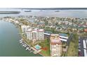 Wide aerial showcasing building location near water and tennis courts at 700 Island Way # 504, Clearwater, FL 33767