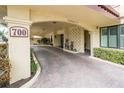 Covered parking with paver driveway and lush landscaping at 700 Island Way # 504, Clearwater, FL 33767