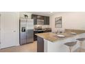 Eat-in kitchen with stainless steel appliances and granite countertops at 7812 Wheat Stone Dr, Zephyrhills, FL 33540