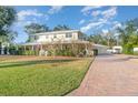 Two-story house with a paver driveway and lush landscaping at 7312 7Th Nw Ave, Bradenton, FL 34209