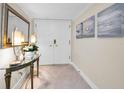 Bright and airy entryway with decorative console table at 100 Oakmont Ln # 602, Belleair, FL 33756