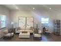 Light and airy living room featuring a beige sofa and wooden accents at 1046 Bass Blvd, Dunedin, FL 34698