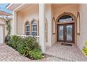 Inviting front entrance with arched windows and double doors at 10553 Bermuda Isle Dr, Tampa, FL 33647