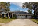 Spacious home with a three-car garage and mature trees at 10745 Bardes Ct, Seminole, FL 33777