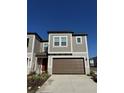 Two-story townhome with brown garage door and gray exterior at 10812 Fanning Springs Ct, Tampa, FL 33647