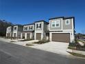 Row of townhomes with gray exteriors and brown garage doors at 10812 Fanning Springs Ct, Tampa, FL 33647