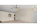 Living room featuring tile floors and a ceiling fan at 11013 Cranston St, Spring Hill, FL 34608