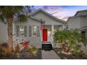 Charming house exterior at dusk with well-manicured landscaping at 11220 Moultrie Pl, Tampa, FL 33625