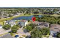 Aerial view of a home near a pond in a neighborhood with lots of trees at 11540 Balintore Dr, Riverview, FL 33579