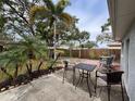 Backyard patio with table and chairs, surrounded by palm trees at 12264 103Rd St, Largo, FL 33773