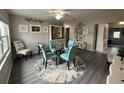 Dining room with glass table, four teal chairs, and area rug at 12264 103Rd St, Largo, FL 33773