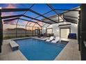 Screened pool and patio area with lounge chairs and outdoor seating at 16961 Oval Rum Dr, Wimauma, FL 33598