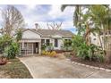 House exterior showcasing a carport and lush landscaping at 17 Venetian Ct, Tarpon Springs, FL 34689