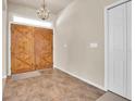 Entryway with double wooden doors and tile flooring at 18420 Burrell Rd, Odessa, FL 33556