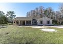 House exterior showcasing a front porch and landscaping at 18420 Burrell Rd, Odessa, FL 33556